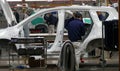 Workers assemble a car on assembly line in car factory