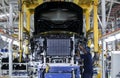 Workers assembles cars at automobile assembly line production plant