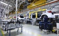 Workers assembles cars at automobile assembly line production plant