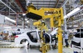 Workers assembles cars at automobile assembly line production plant