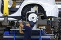 Workers assembles cars at automobile assembly line production plant