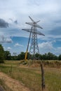 workers assembling a power pole at high altitude