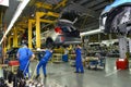 Workers on the assembly conveyor of automobile plant