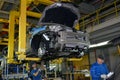 Workers on the assembly conveyor of automobile plant