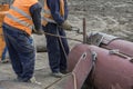 Workers bent metal rods with flame torch