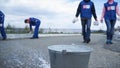 Workers in blue are ready to work for the city in outdoor. Clip. Closeup of a worker. Workers in blue dip the brush in Royalty Free Stock Photo