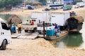 Workers in a boat with their vehicles waiting for cross the river in Guatemala