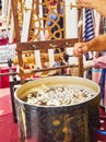 Workers boiling and unwinding silkworm cocoons to make silk thread at an Arab market of Istanbul. Royalty Free Stock Photo