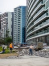 Workers break off concrete. Hard work. People are reconstructing the sidewalk. Hotel reconstruction