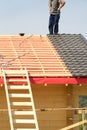 Workers build a roof on the house. Royalty Free Stock Photo
