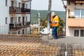 Workers building house and pouring cement and concrete over reinforced steel bars at construction site. Industrial details Royalty Free Stock Photo