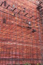 Workers building scaffolding on the wall of Taj Mahal complex in