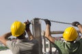 Workers building stage truss construction