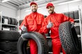 Workers with car tires at the warehouse Royalty Free Stock Photo