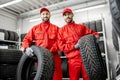 Workers with car tires at the warehouse Royalty Free Stock Photo