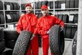 Workers with car tires at the warehouse Royalty Free Stock Photo