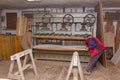 Workers in carpentry placed glued wooden profiles in the large clamp machine for pressing