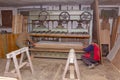 Workers in carpentry placed glued wooden profiles in the large clamp machine for pressing