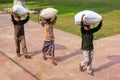 Workers carrying bags on their heads at Taj Mahal complex, Agra, Uttar Pradesh, India