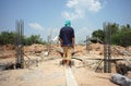 Workers carrys the cement cart and pour in the foundation of house