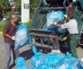 Workers charged with garbage in a garbage truck on city streets Lazarevskoye Royalty Free Stock Photo