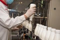 Workers check a bottle of milk on a modern dairy plant