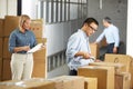 Workers Checking Goods On Belt In Distribution Warehouse Royalty Free Stock Photo