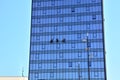 Workers clans window on big building outside