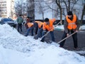 Workers clean snow