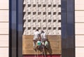 Workers cleaning front of a shopping mall, Changchun, China