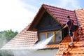 Roof cleaning with high pressure cleaner Royalty Free Stock Photo