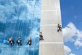 Workers cleaning windows mirror service on high rise building