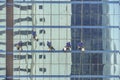 Workers cleaning windows service on high rise building Royalty Free Stock Photo