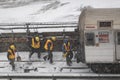 Workers clearing frozen snow from railroad track in Manhattan USA.