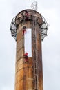 Workers climbing on the big chimney Royalty Free Stock Photo