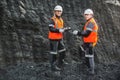 Workers with coal at open pit