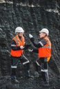 Workers with coal at open pit Royalty Free Stock Photo