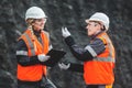 Workers with coal at open pit