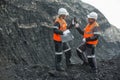 Workers with coal at open pit Royalty Free Stock Photo