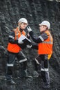 Workers with coal at open pit