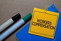 Workers Compensation write on sticky notes isolated on Office Desk