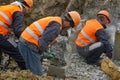 Workers at the construction site chop a jackhammer piles are cut