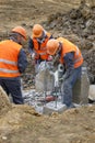 Workers at the construction site chop a jackhammer piles are cut