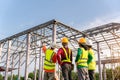 4 Workers in Construction Site, Contractor with workers and Steel roof structure under construction background Royalty Free Stock Photo