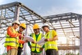 4 Workers in Construction Site, Happy of Engineer technician and Architect use blue print Planing together before starting work. Royalty Free Stock Photo