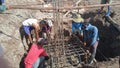 Workers on a construction site work together