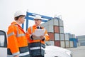 Workers conversing in shipping yard