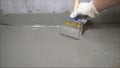 The process of applying mortar - waterproofing to a concrete floor. The concept of waterproofing the floor with a brush. Royalty Free Stock Photo