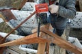 Workers cut the rafters on the roof of the chainsaw house