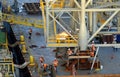 Workers cut the welds securing offshore module to a huge work barge in Bass Strait